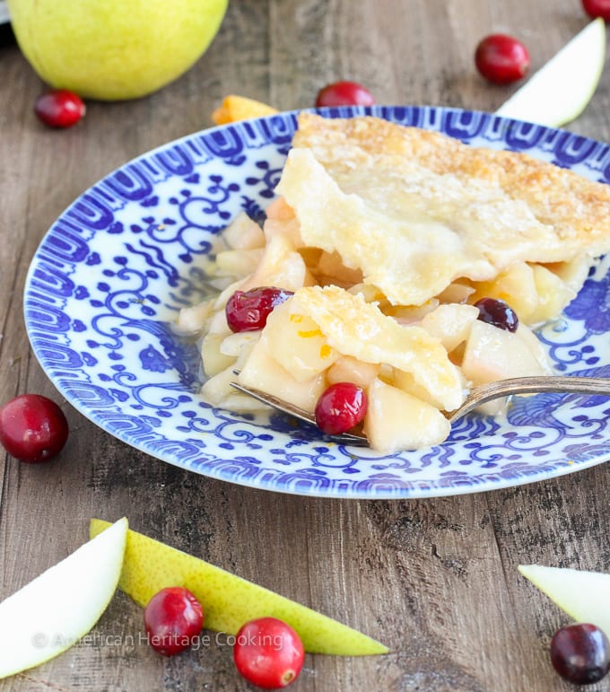This Cranberry Orange Pear Pie has a sweet brown sugar orange pear filling and is studded with tart cranberries! With fresh orange juice, zest and Grand Marnier, the flavors are absolute heaven! 