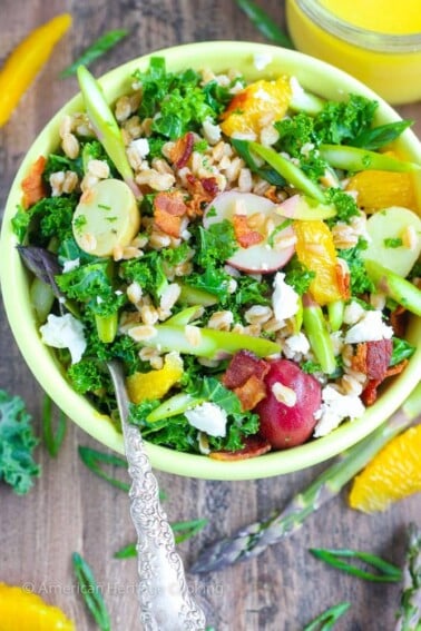 In this Asparagus Orange Farro Salad boiled new potatoes, crispy raw asparagus, chewy farro, peppery scallions, salty feta and crispy bacon all get tossed in a bright orange vinaigrette for a mouthful of Spring flavors!