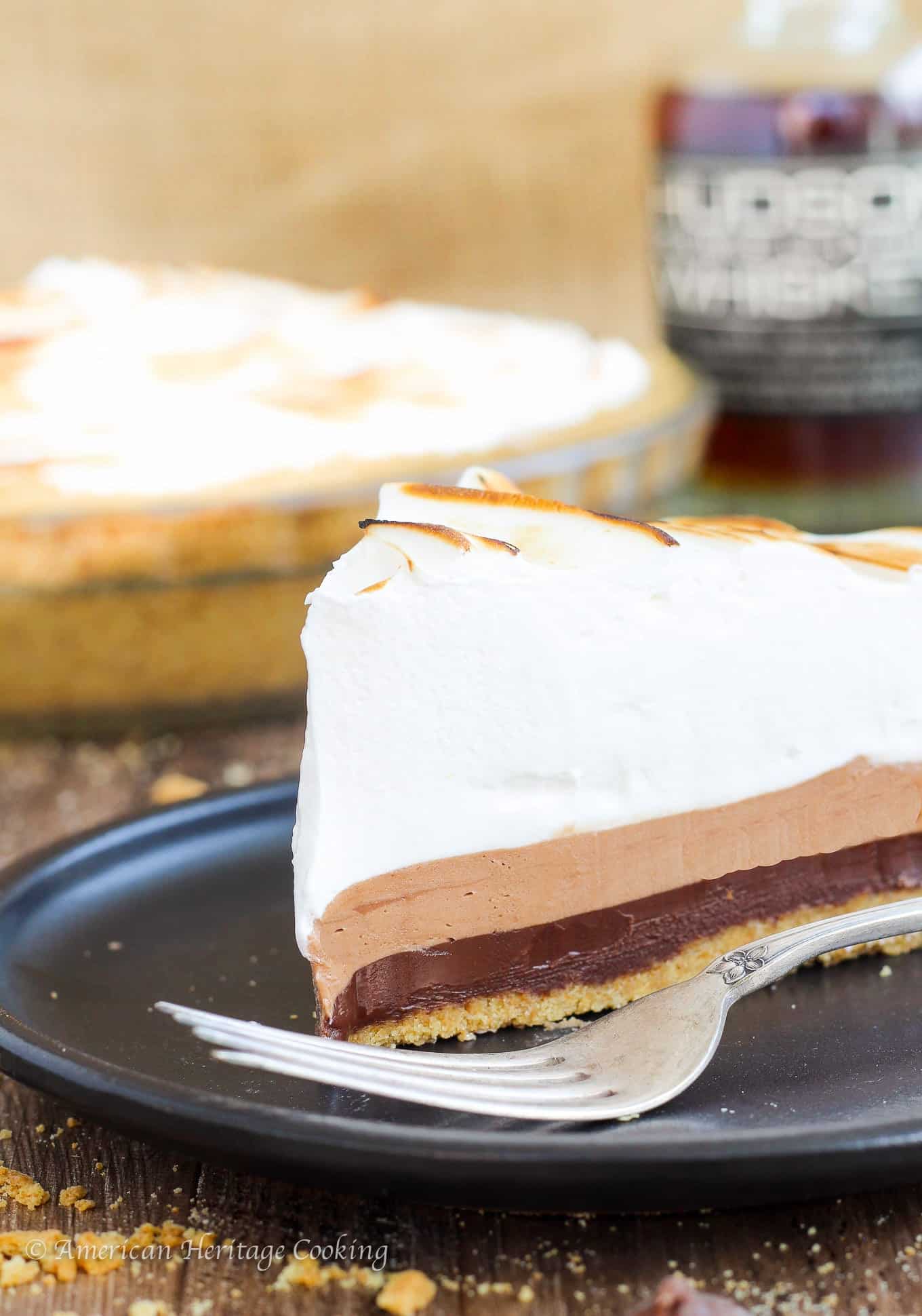 This No Bake Whiskey Smores Pie is a slice of Summer Heaven! There are layers of dark chocolate whisky ganache, milk chocolate mousse and fluffy toasted marshmallow in the perfect graham cracker crust. Go ahead…help yourself to another slice. 