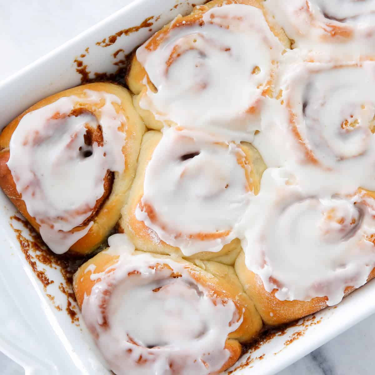 Sourdough Cinnamon Rolls Iced in white dish