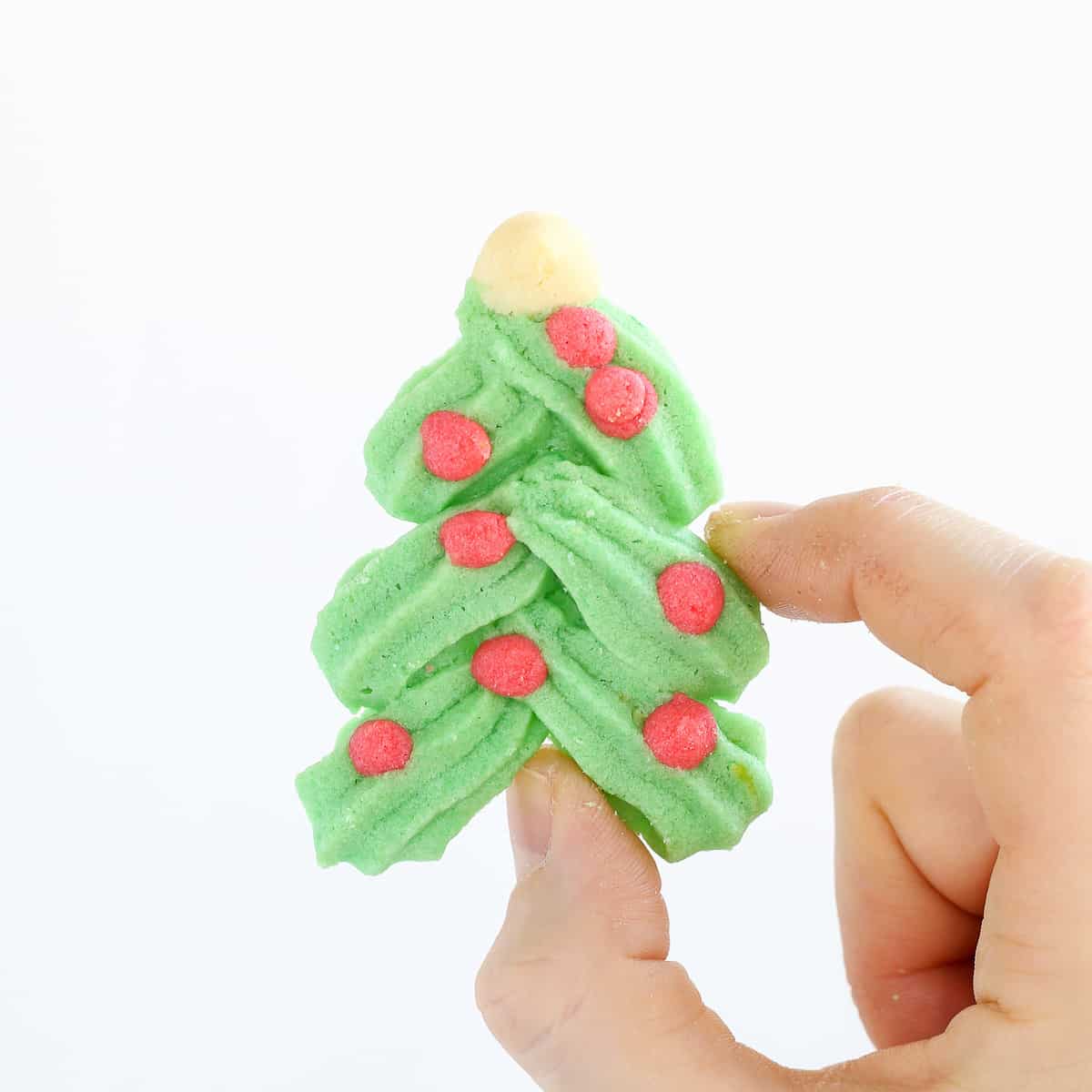 Holiday Spritz cookie Christmas tree in hand.