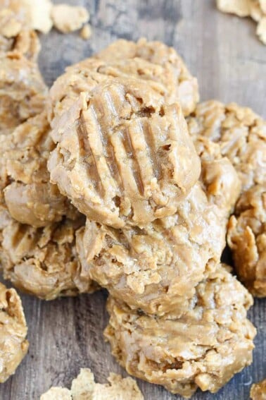 No Bake Peanut Butter Cookies stacked on wooden surface.