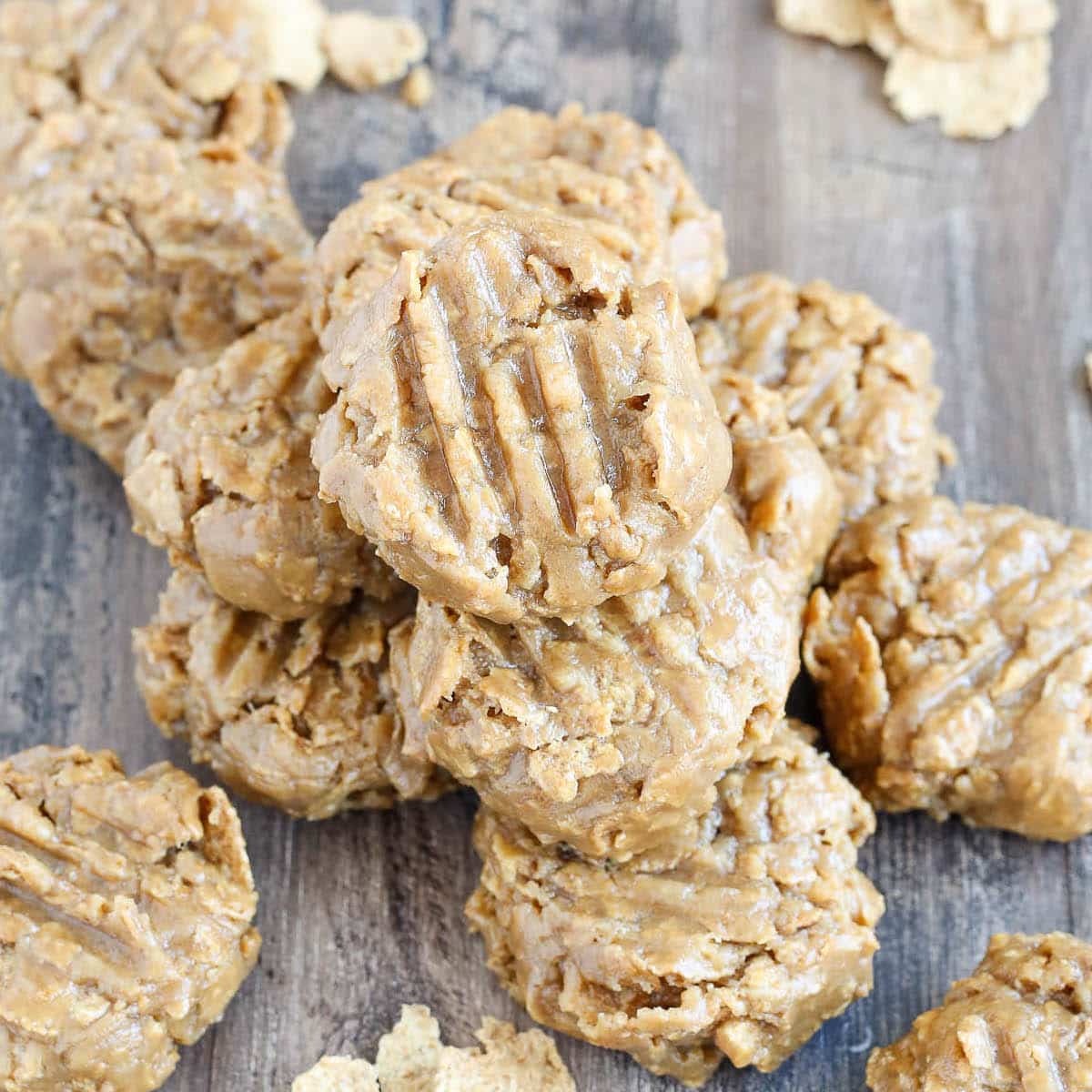 No Bake Peanut Butter Cookies stacked on wooden surface.