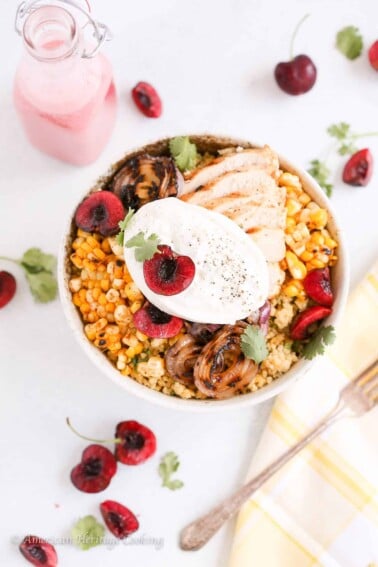 This Cherry Burrata Millet Grain Bowl has nutty millet, grilled red onions, charred shallots, spicy corn, grilled chicken, fresh cherries, creamy Burrata and a bright cherry vinaigrette! It’s the summer bowl to eat on repeat.