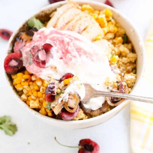 This Cherry Burrata Millet Grain Bowl has nutty millet, grilled red onions, charred shallots, spicy corn, grilled chicken, fresh cherries, creamy Burrata and a bright cherry vinaigrette! It’s the summer bowl to eat on repeat.