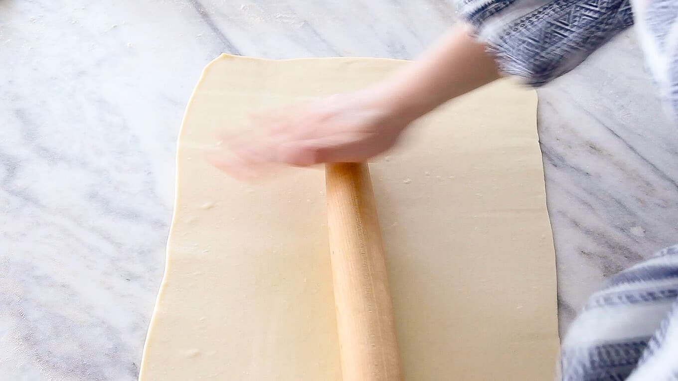 Inverse Puff Pastry sheet being rolled with pin