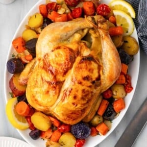 cooked chicken with vegetables on serving platter.