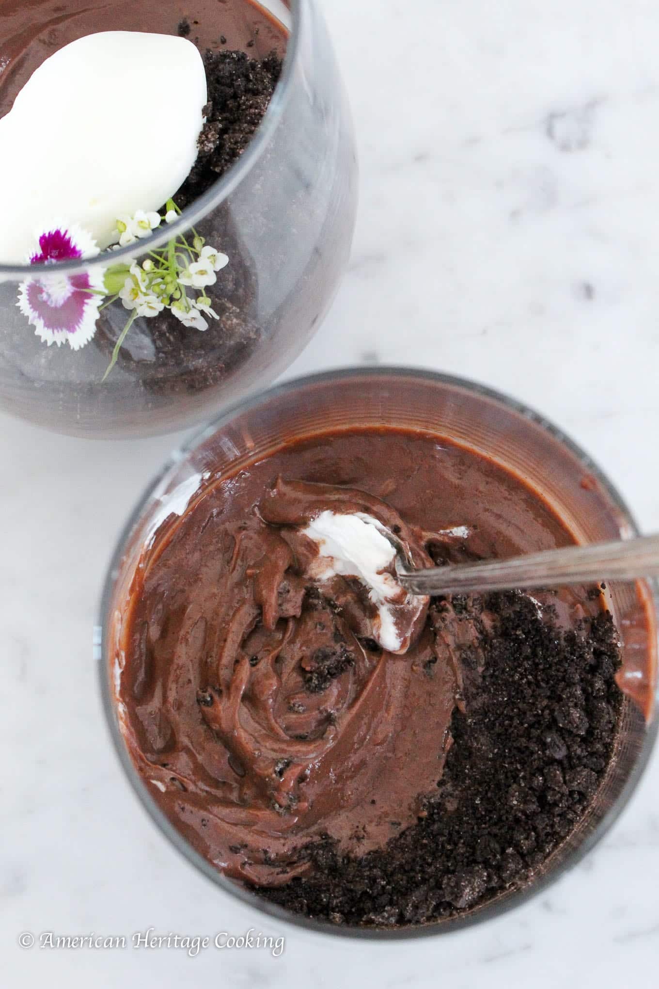 Dark chocolate pudding in a clear cup.