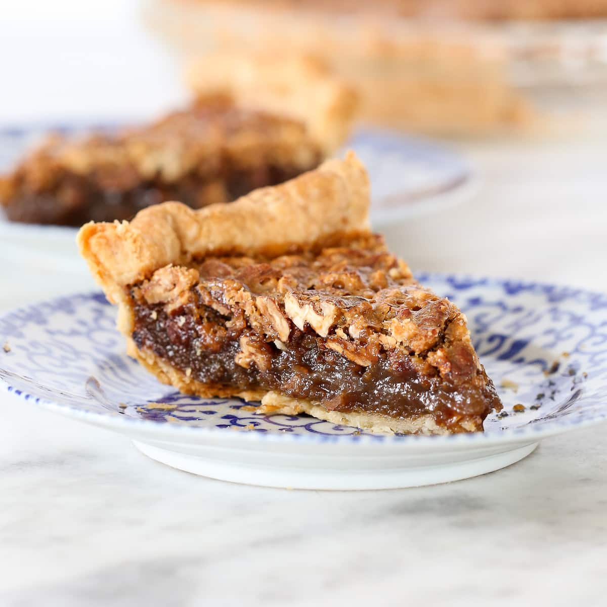 Bourbon Pecan Pie slice on blue plate