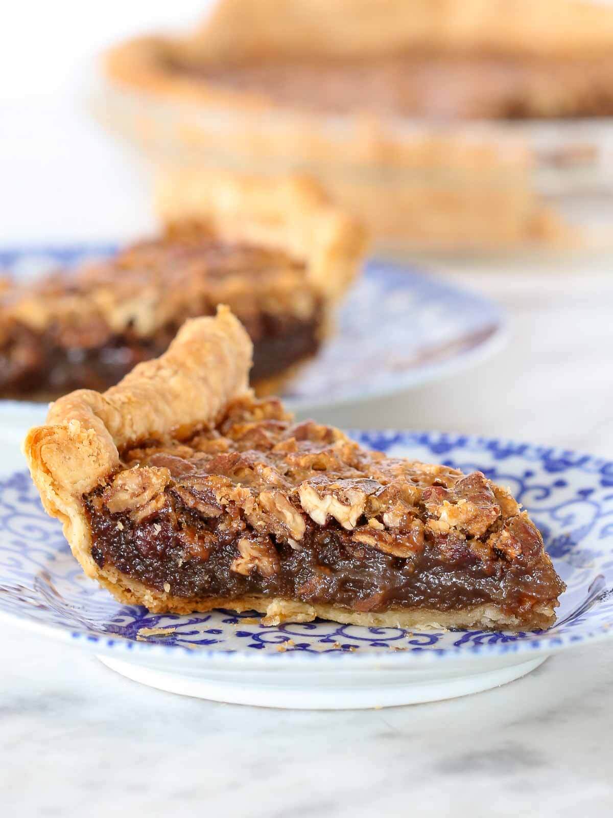 bourbon pecan pie slices on blue plates. 