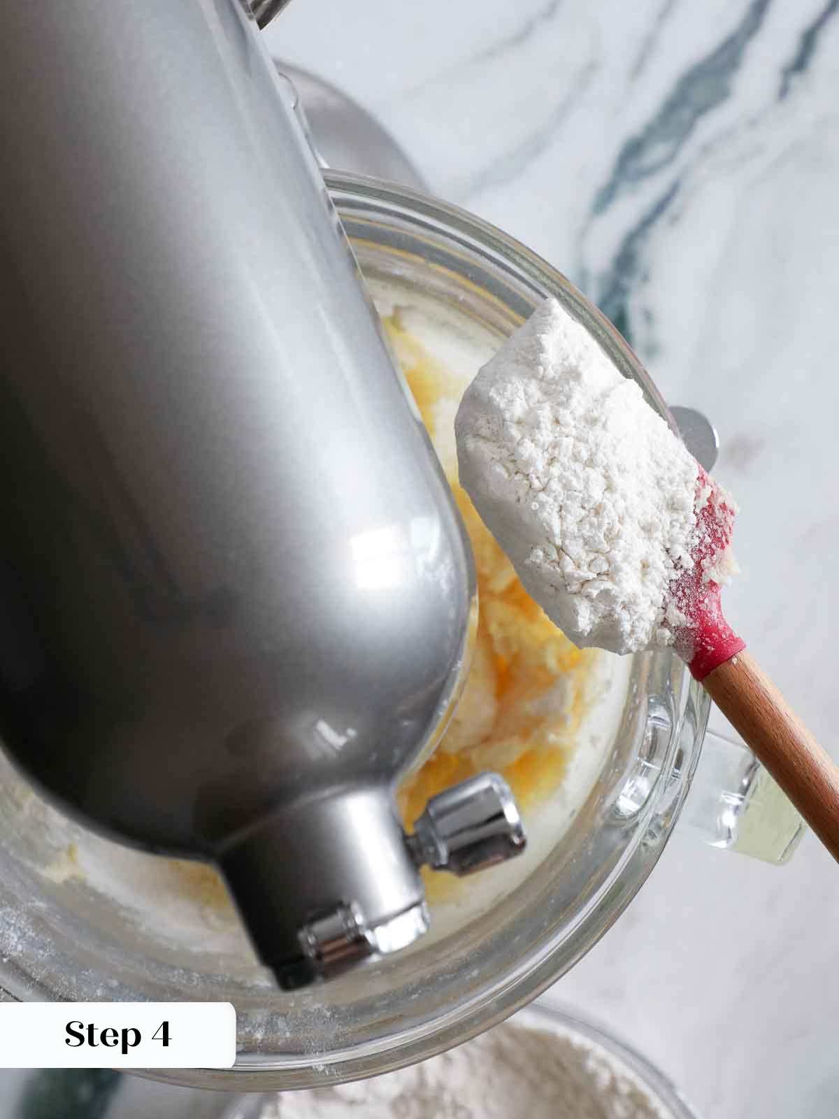 adding dry ingredients to sugar cookies.