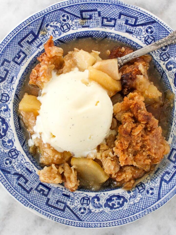 Classic Apple Crisp with Oat Streusel on plate with ice cream
