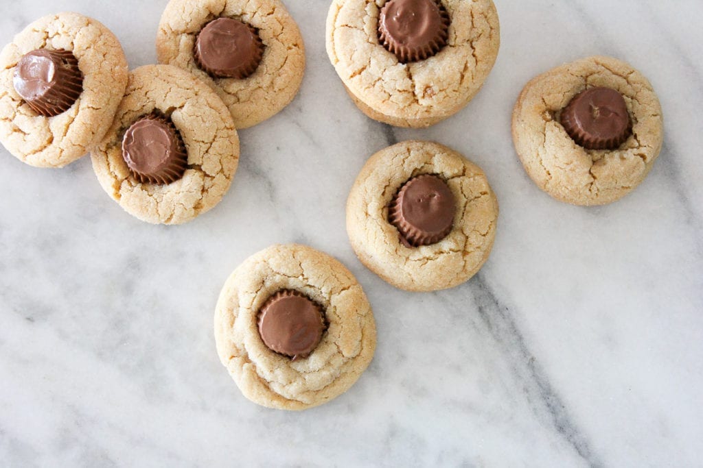 These Peanut Butter Cup Blossoms are like the cookies you grew up making but with a mini Reese’s cup pressed into the center of each one!