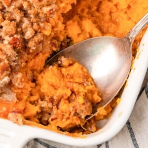 sweet potato casserole being served with spoon.