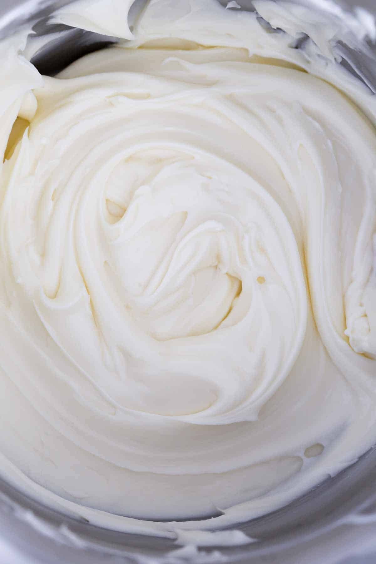 cream cheese buttercream frosting in metal mixing bowl. 