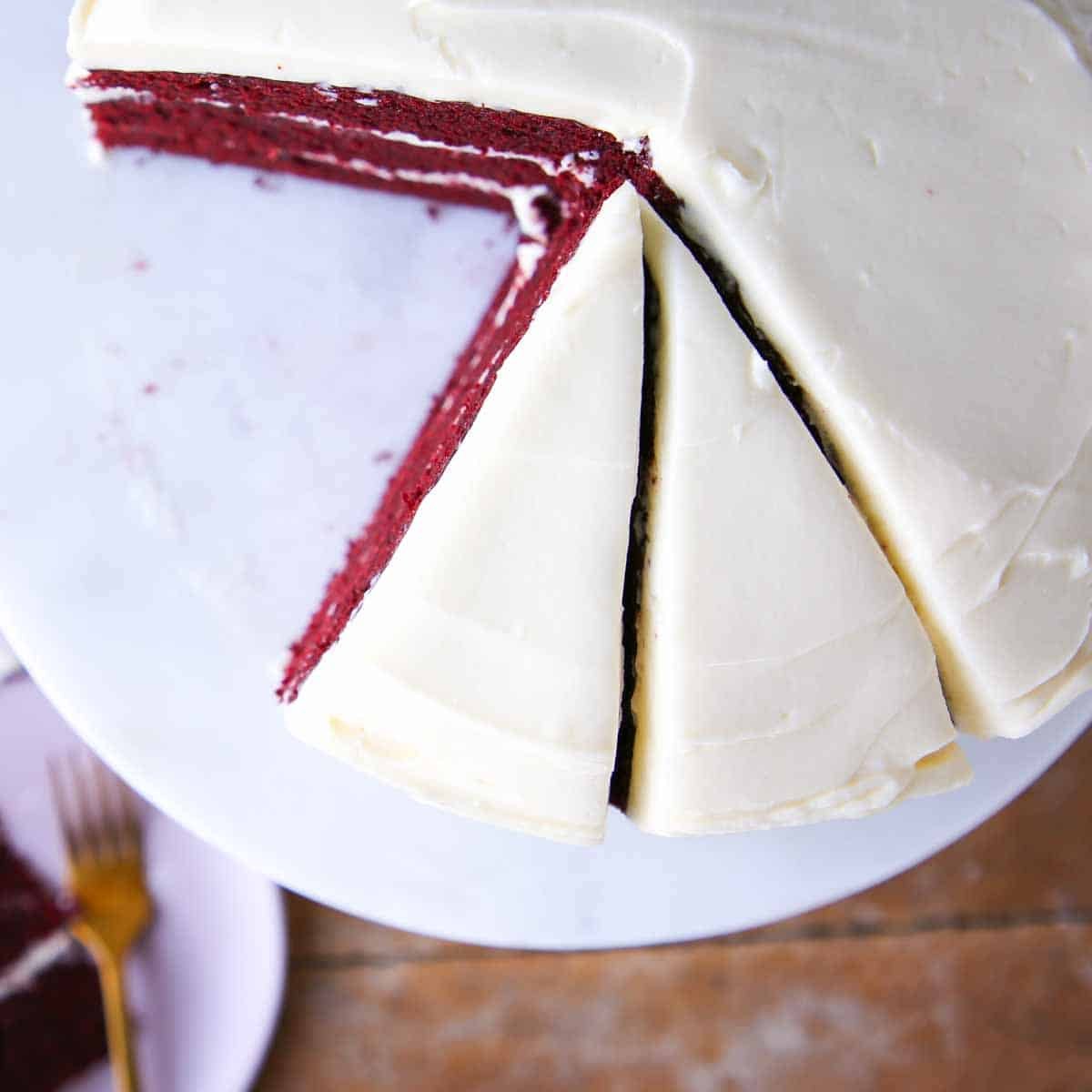 red velvet cake sliced with bourbon cream cheese buttercream marble cake stand.