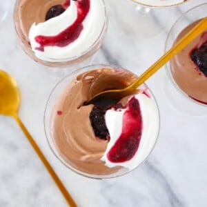 Chocolate Mousse in glass with gold spoon.