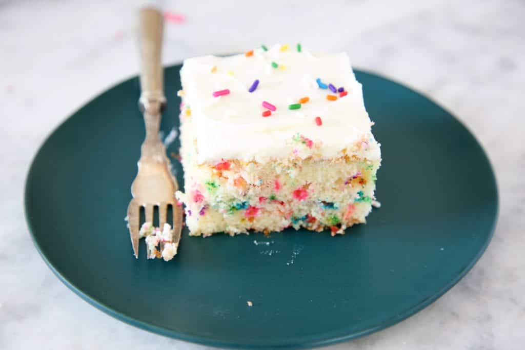 This Funfetti Sheet Cake is decadently moist and packed full of rainbow sprinkles! 