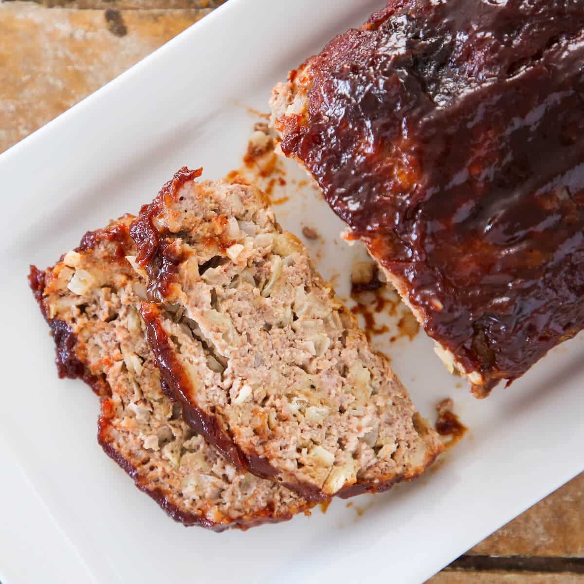 The best meatloaf sliced on white plate detailed texture