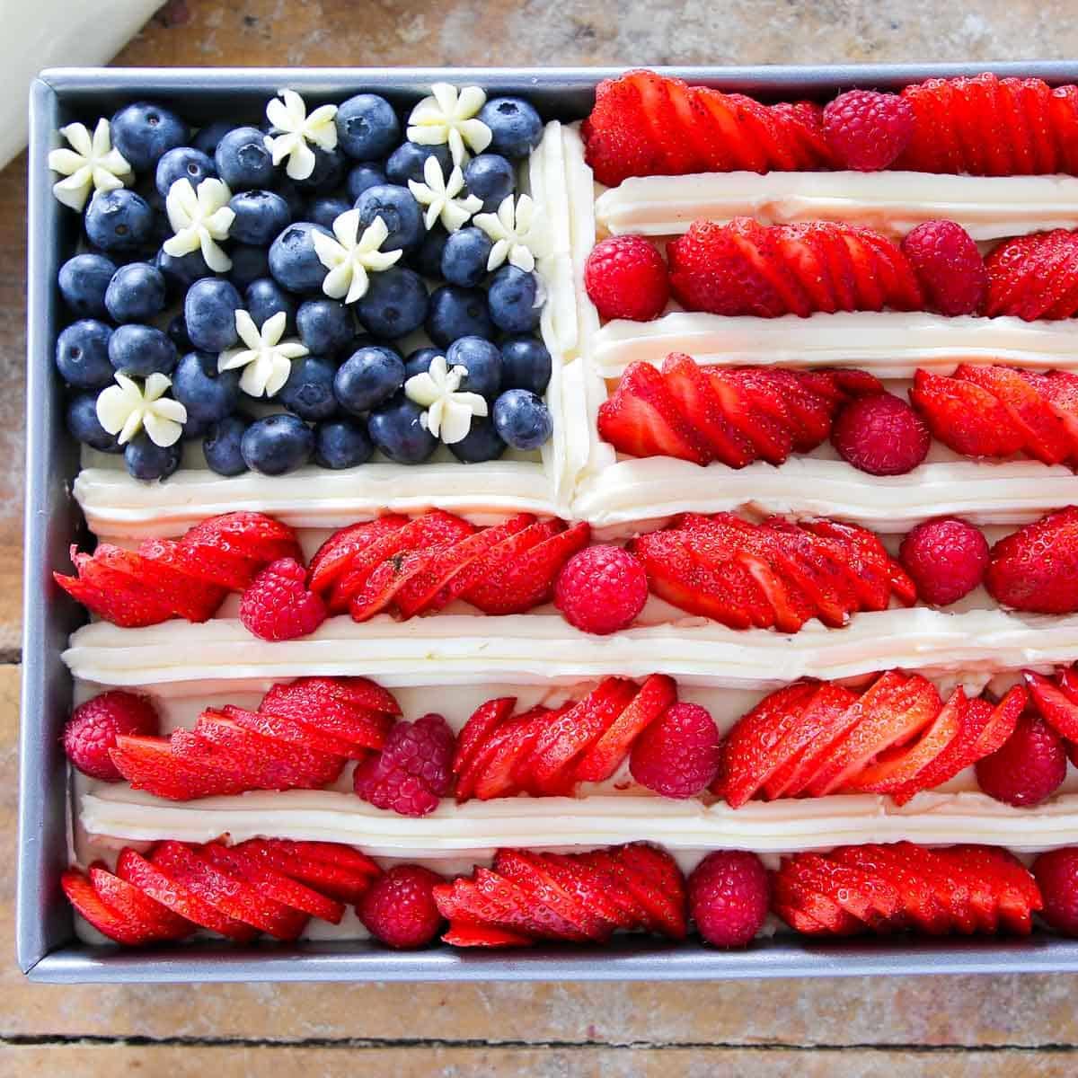 american flag cake with berries and swiss meringue buttercream.