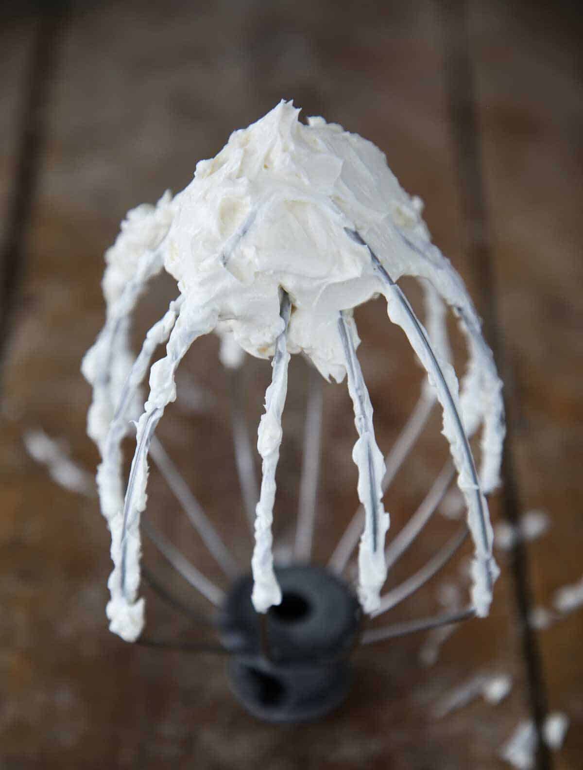 Swiss meringue buttercream on whisk.