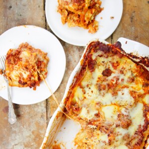 Ultimate Lasagna Recipe slices on two plate with cheese pull