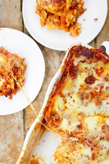 Ultimate Lasagna Recipe slices on two plate with cheese pull