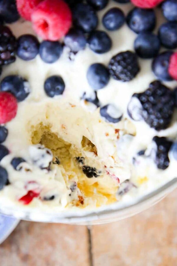 top of trifle dish loaded with berries with serving missing.