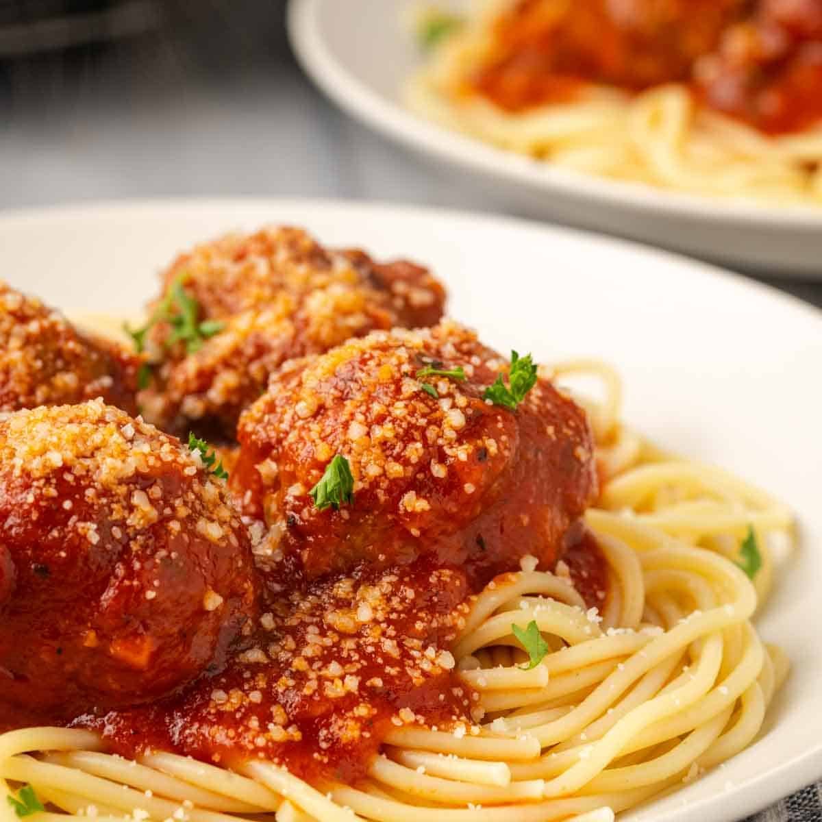 plated meatballs with spaghetti.