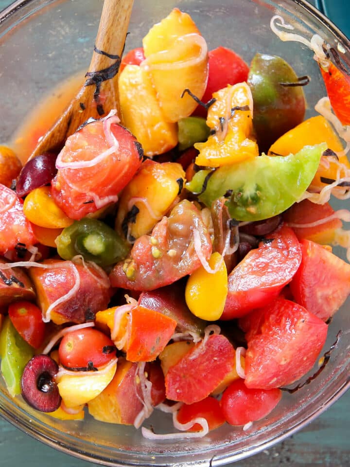 Marinated Tomato Stone Fruit Salad in mixing bowl