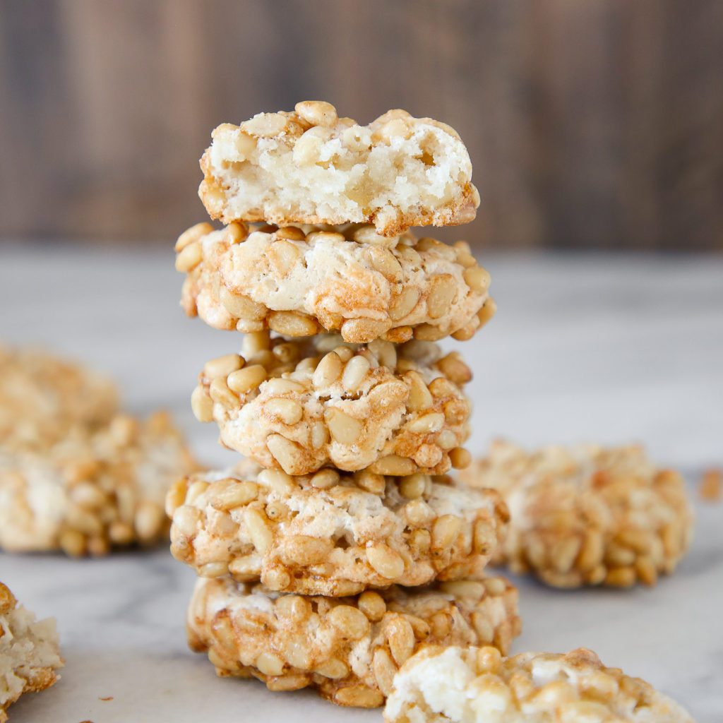 A stack of 5 baked pignoli cookies.