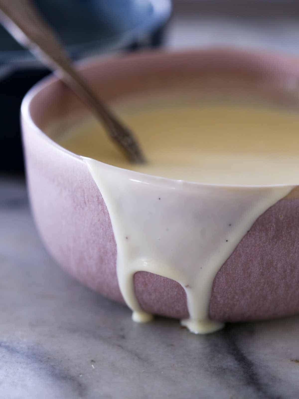 creme anglaise dripping down side of pink bowl.