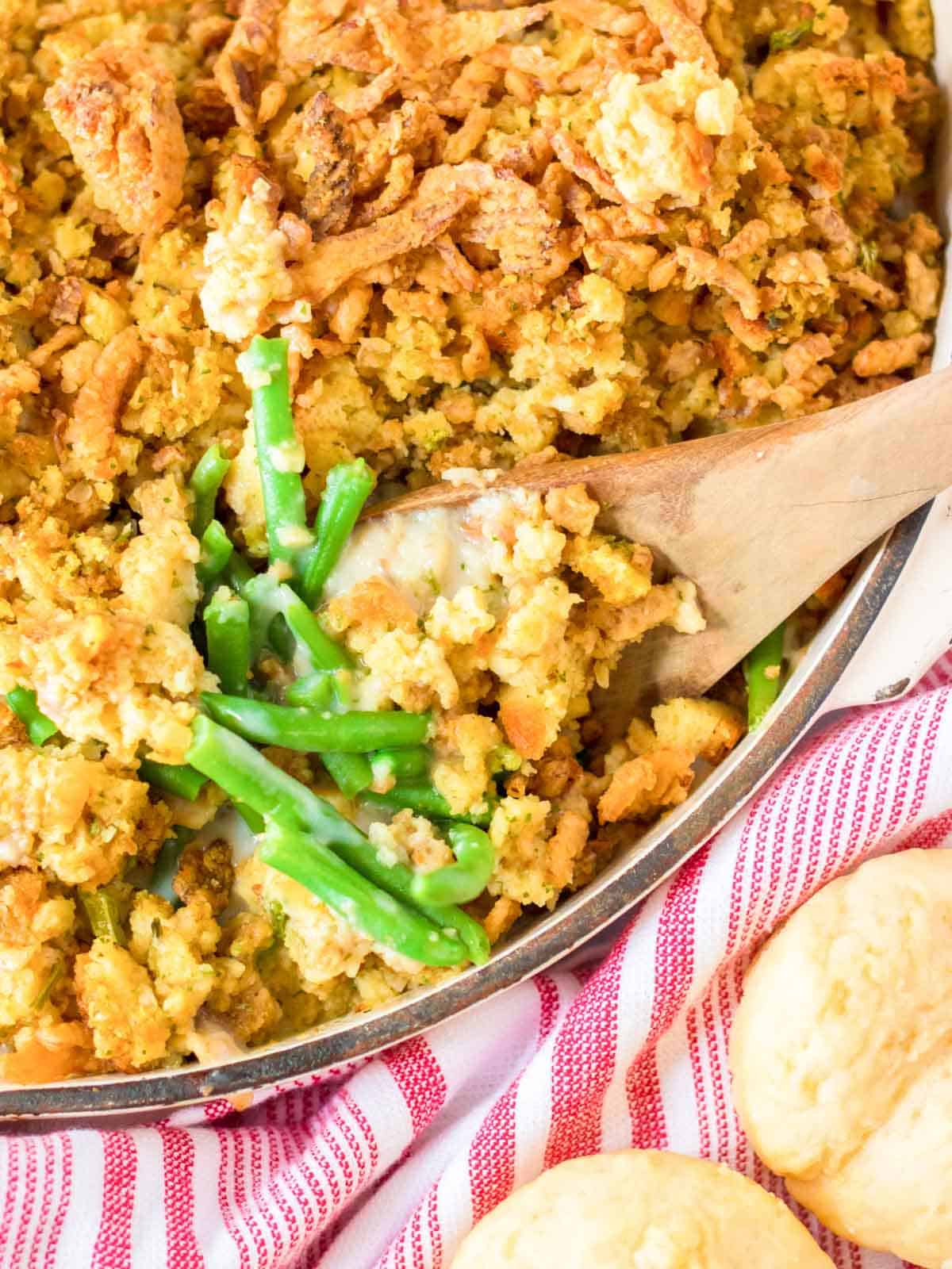green bean casserole in dish with serving spoon. 