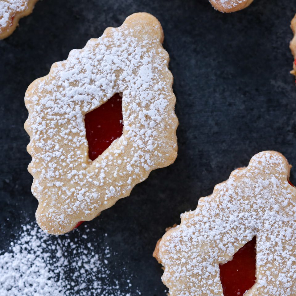 Linzer cookies with powdered sugar sprinkled on top.