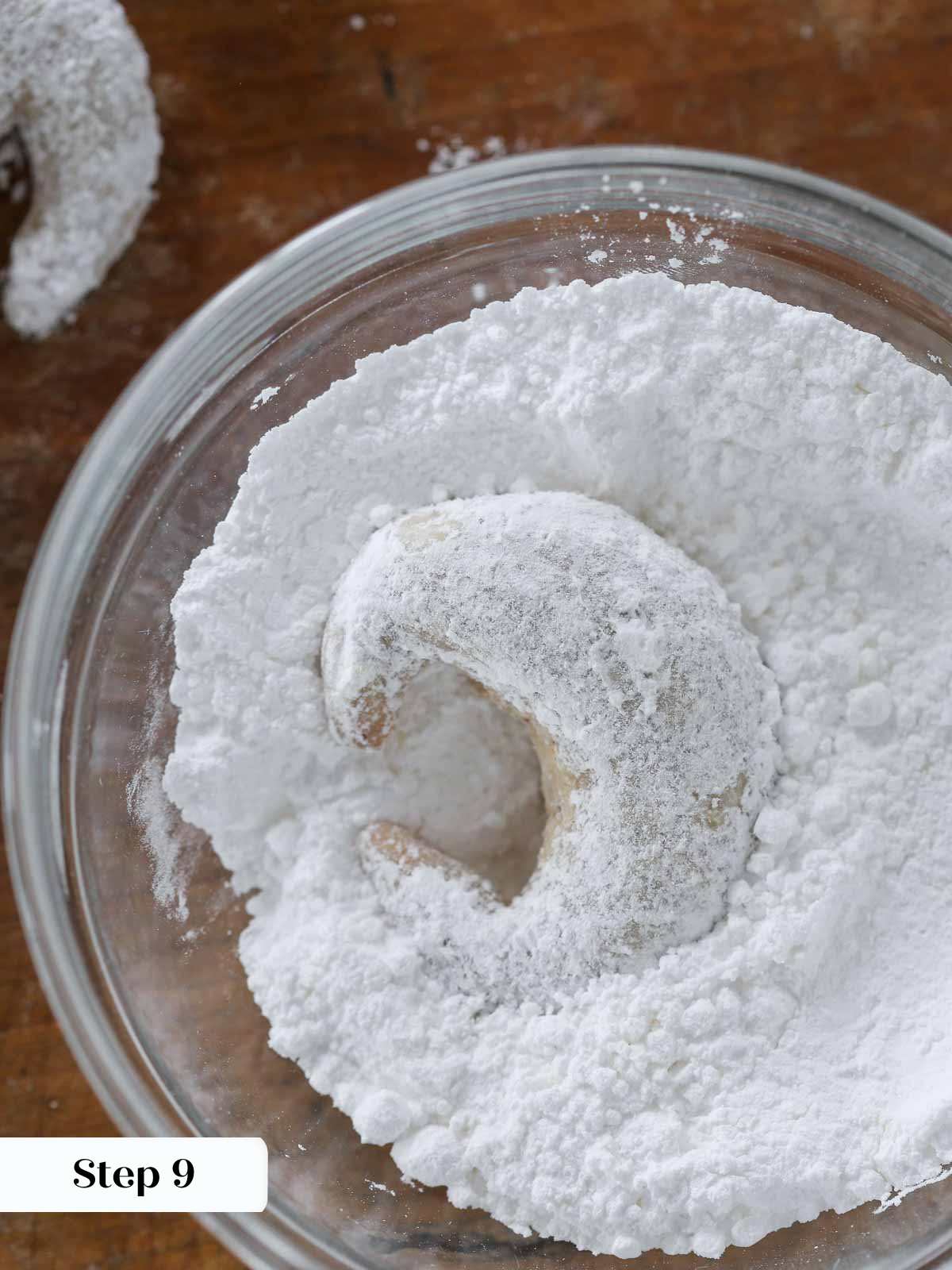 crescent cookie in powdered sugar bowl.
