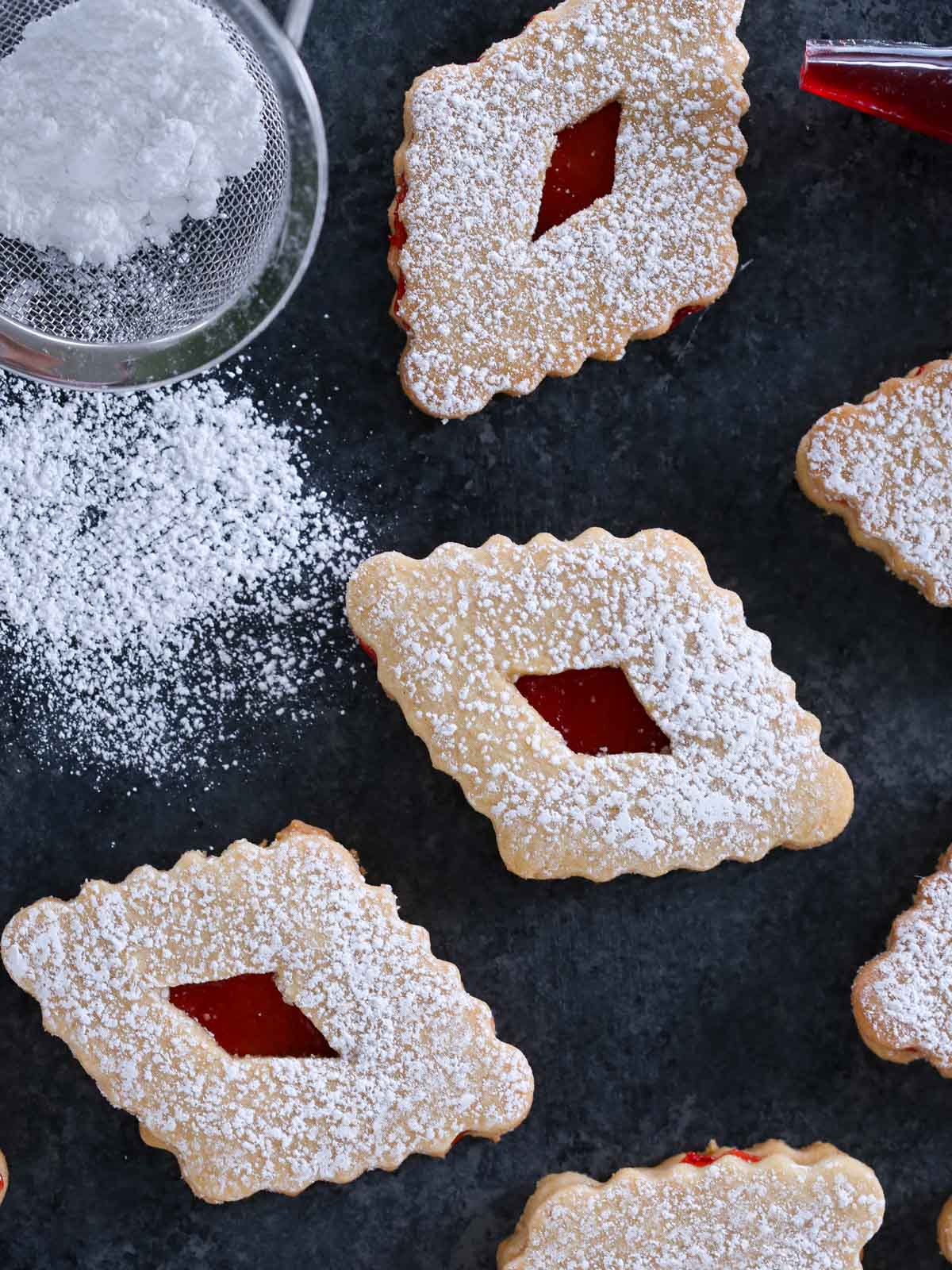 diamond shaped linzers with powdered sugar.