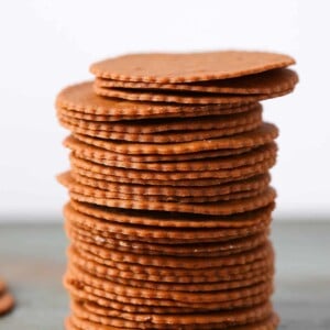 Moravian Christmas Cookies stacked tall green surface