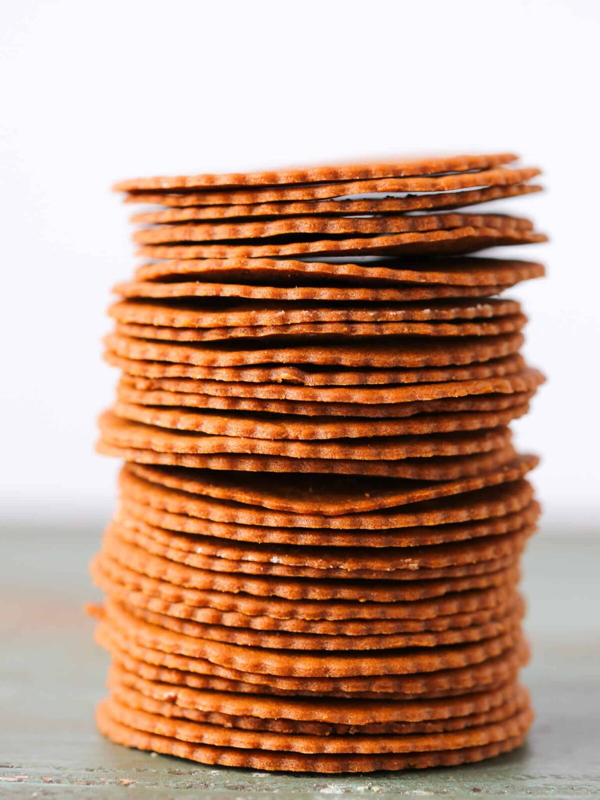 Moravian Christmas Cookies stacked tall white background.