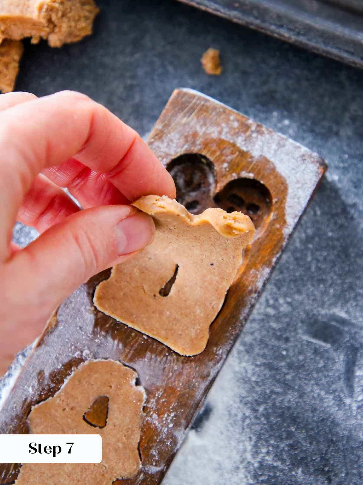 pealing cookie out of mold.