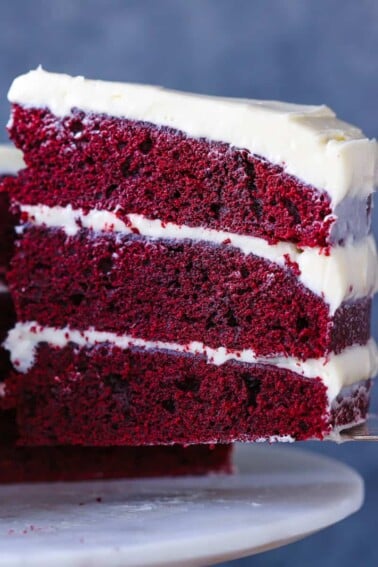Red Velvet Layer Cake Cream Cheese Buttercream slice on cake server.