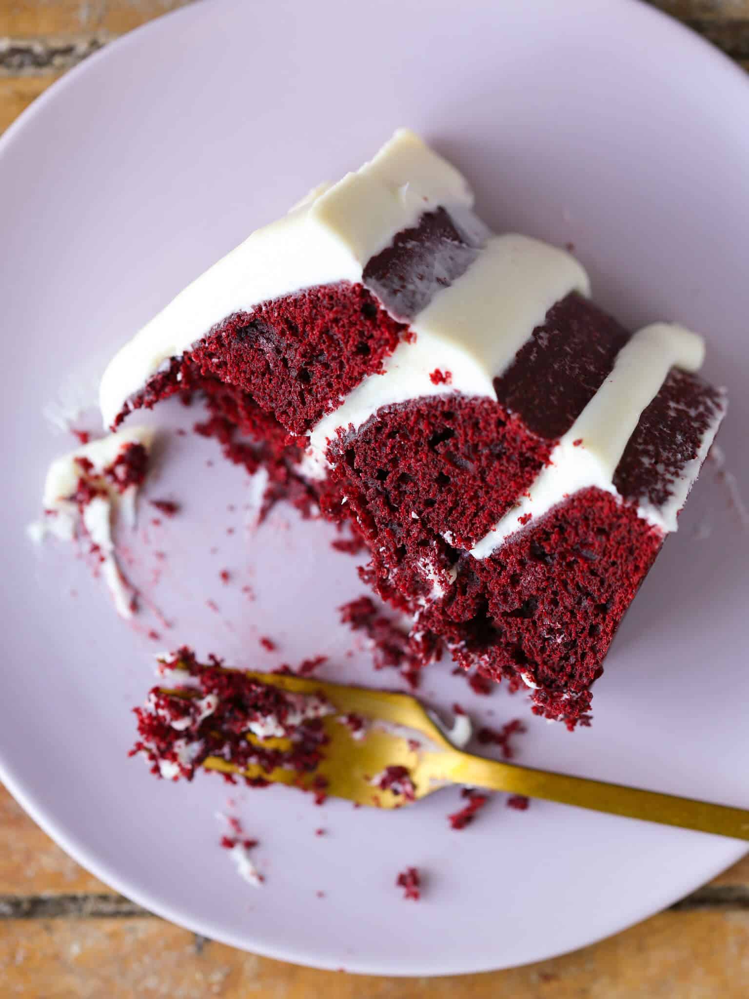 Red Velvet Layer Cake Cream Cheese Buttercream slice on plate partially eaten Valentine's Day Desserts