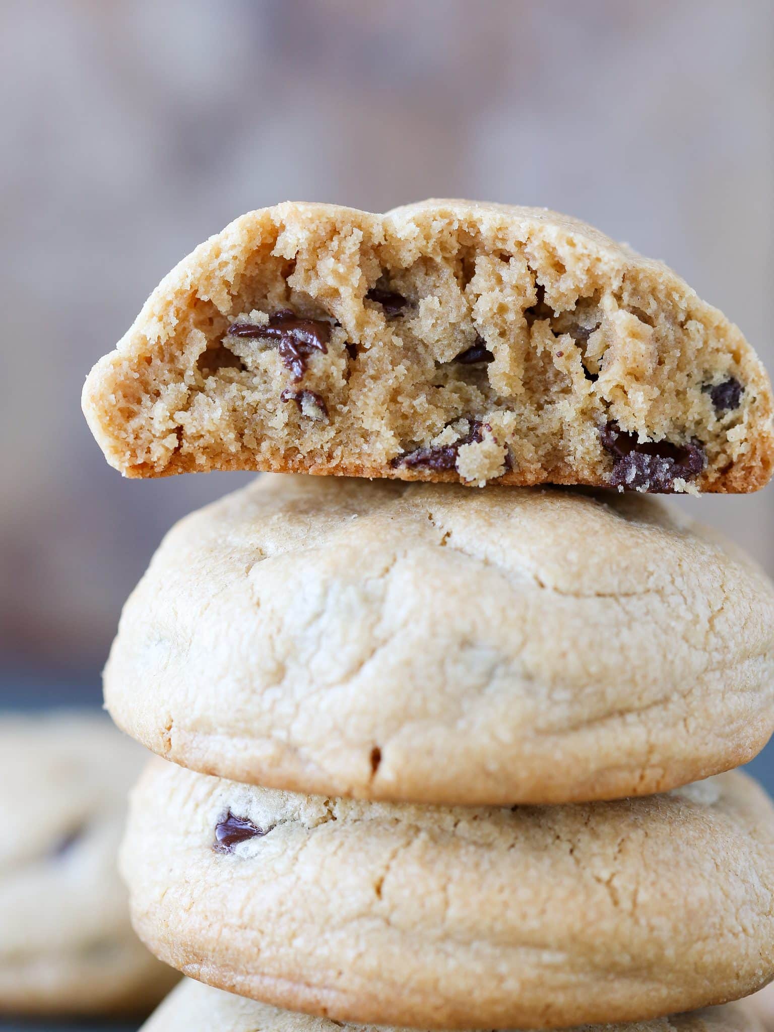 A stack of three thick peanut butter chocolate chip cookies.