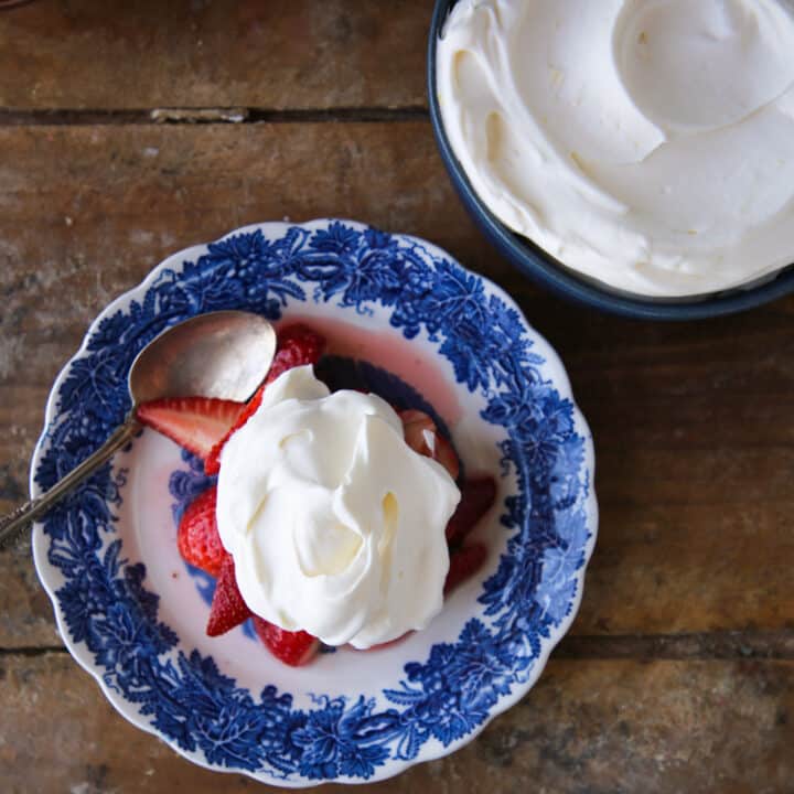 Lemon Whipped Cream on blue plate with strawberries