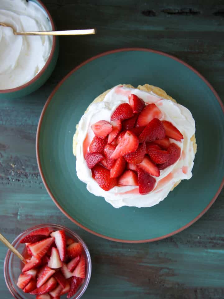 Old Fashioned Strawberry Shortcake on green plate with whipped cream