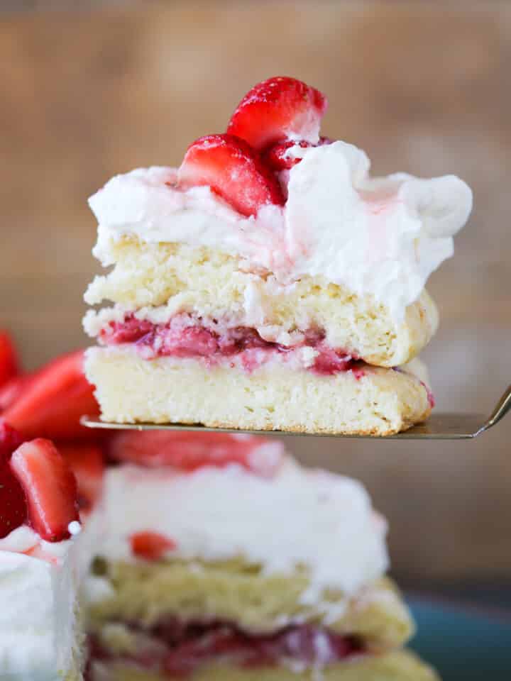 Old Fashioned Strawberry Shortcake slice from side with cake in background