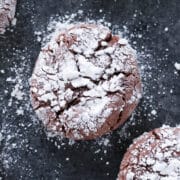 Chocolate Crackle Cookie with powdered sugar on black surface Easy Chocolate Desserts