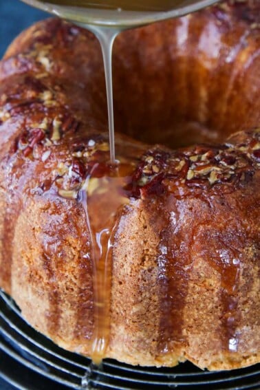Bacardi Rum Cake with glaze actively pouring on top.