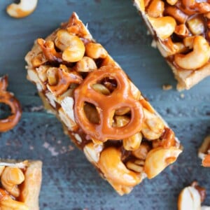 Cashew Caramel Pretzel Blondies on teal wood.