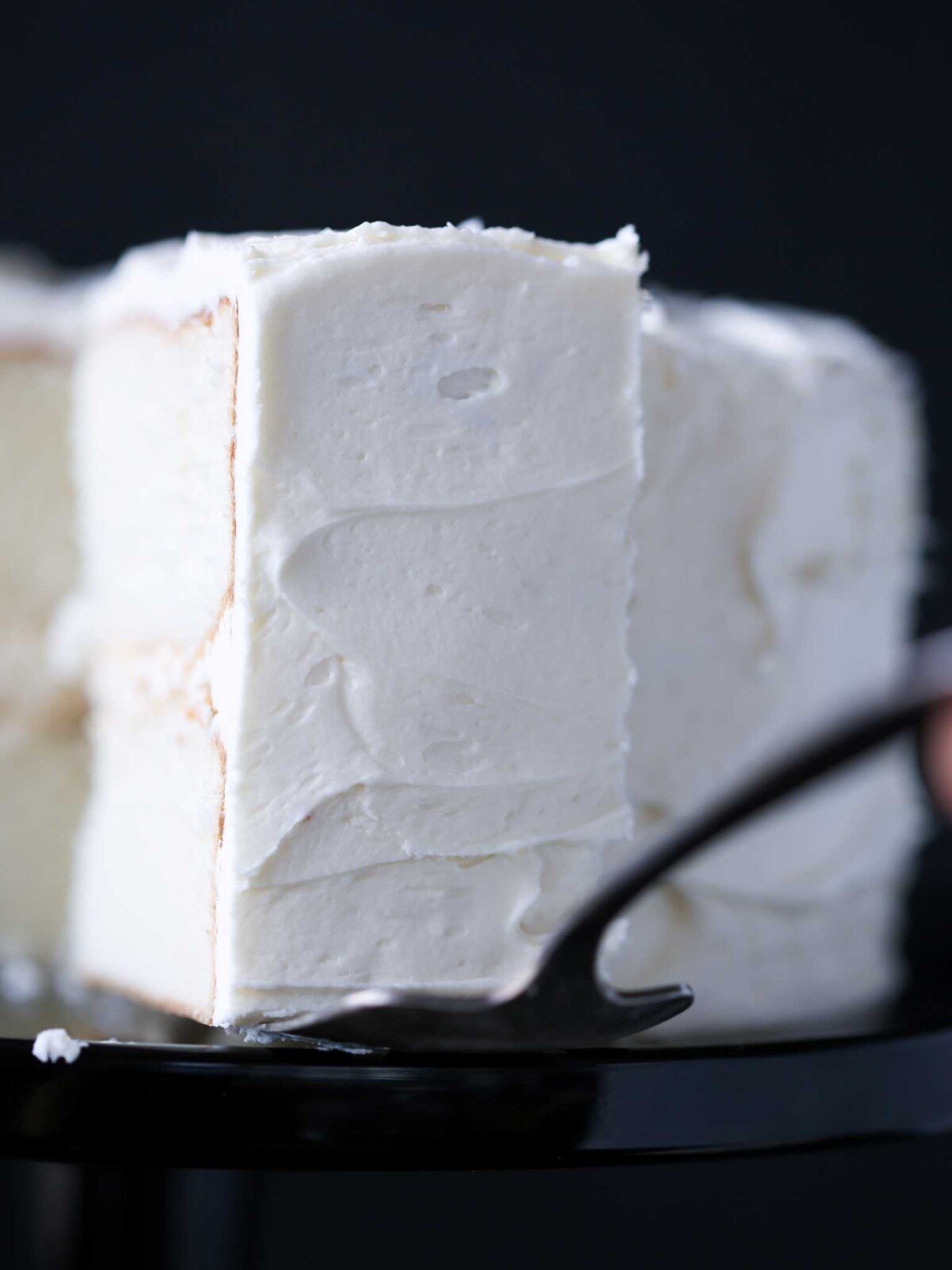 classic white cake on a cake server.
