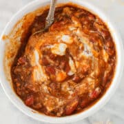 Pinot Noir Chili in bowl with sour cream and cheese